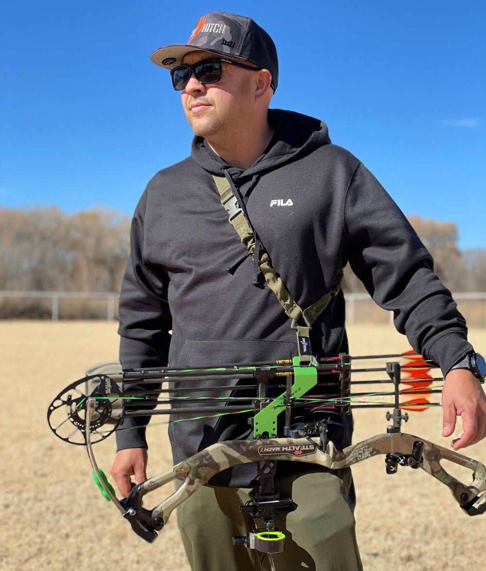 Simply Savage Solutions 2A Bow Sling hitch accessory displayed on a bow, showing durable design and secure attachment features.