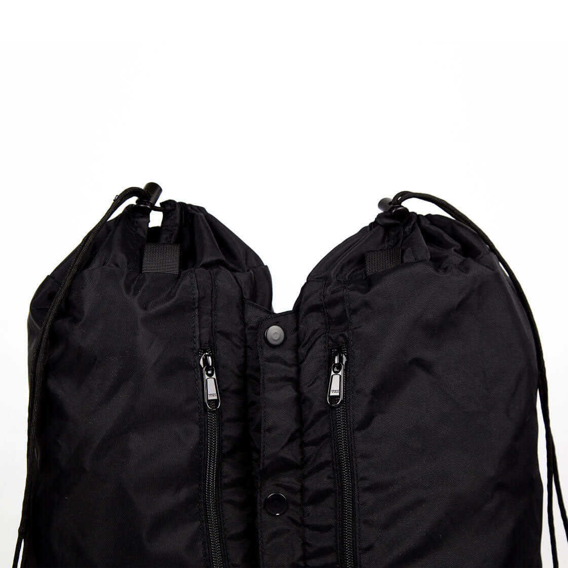Close-up of black Trailform Switch Bags with drawstring straps and zippered pockets for organizing gear.